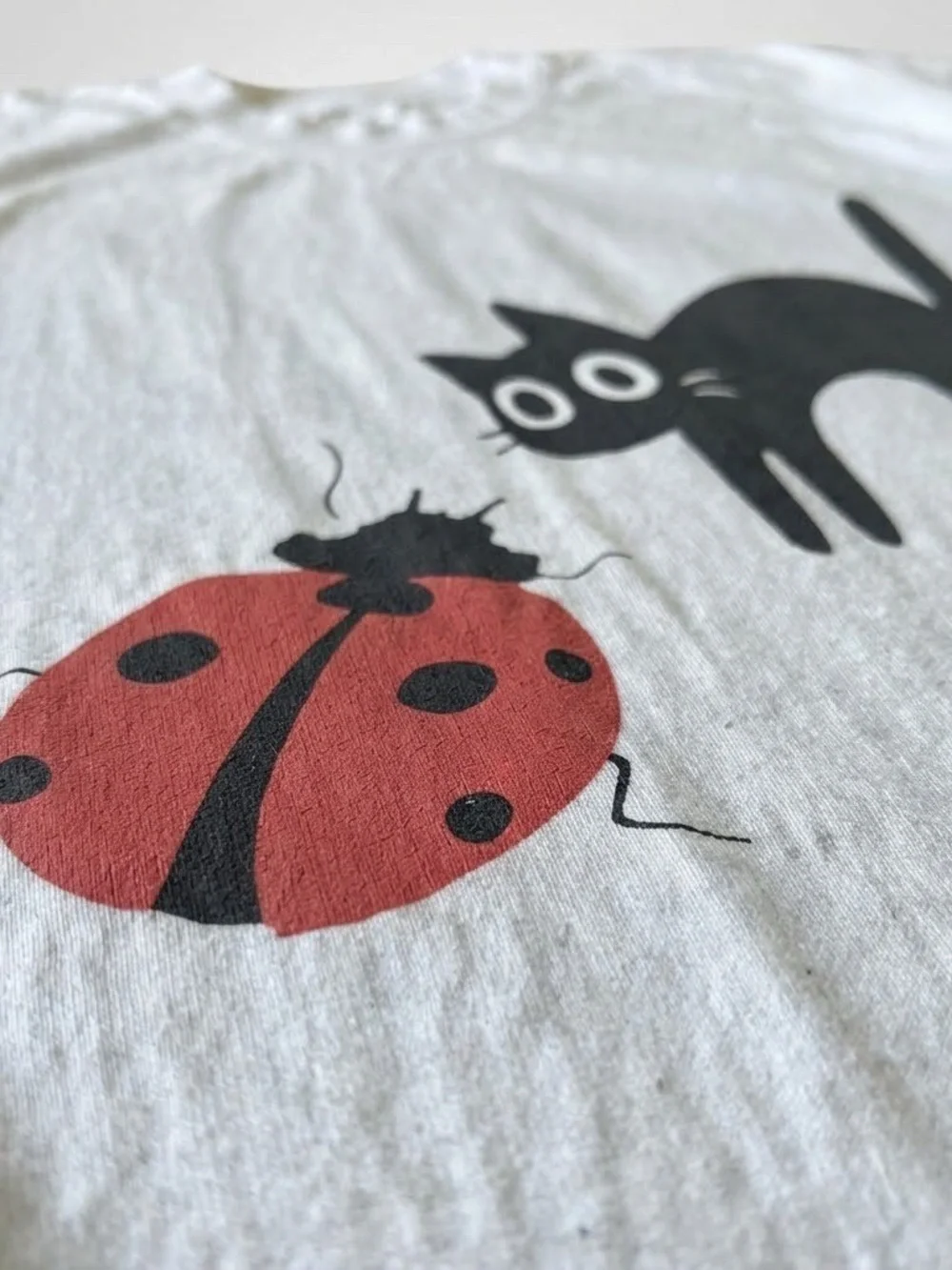 White Tee with Black Cat & Red Ladybug Graphic